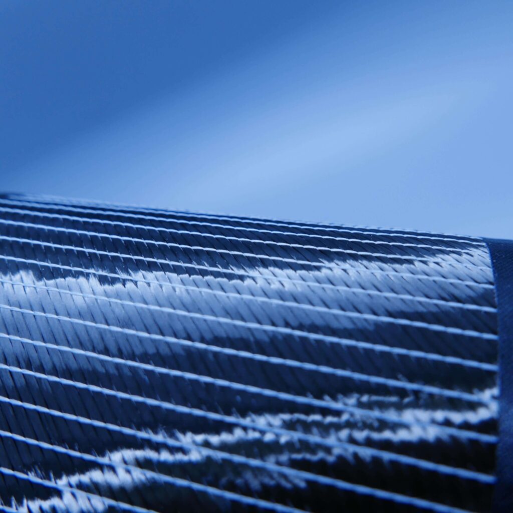Unidirectional carbon fiber heavy weave w/ white stitching